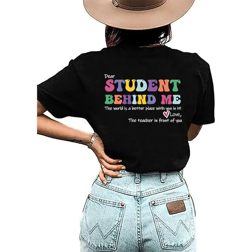 Back View: Spread positivity with the "Dear Student Behind Me, The World Is a Better Place With You In It" T-Shirt from TeachingTeez.com! This inspirational tee is perfect for K-12 educators who want to uplift their students. Made from high-quality fabric, this comfortable black shirt is ideal for any classroom. Show your appreciation and inspire with this cute teacher t-shirt—order yours today at TeachingTeez.com!