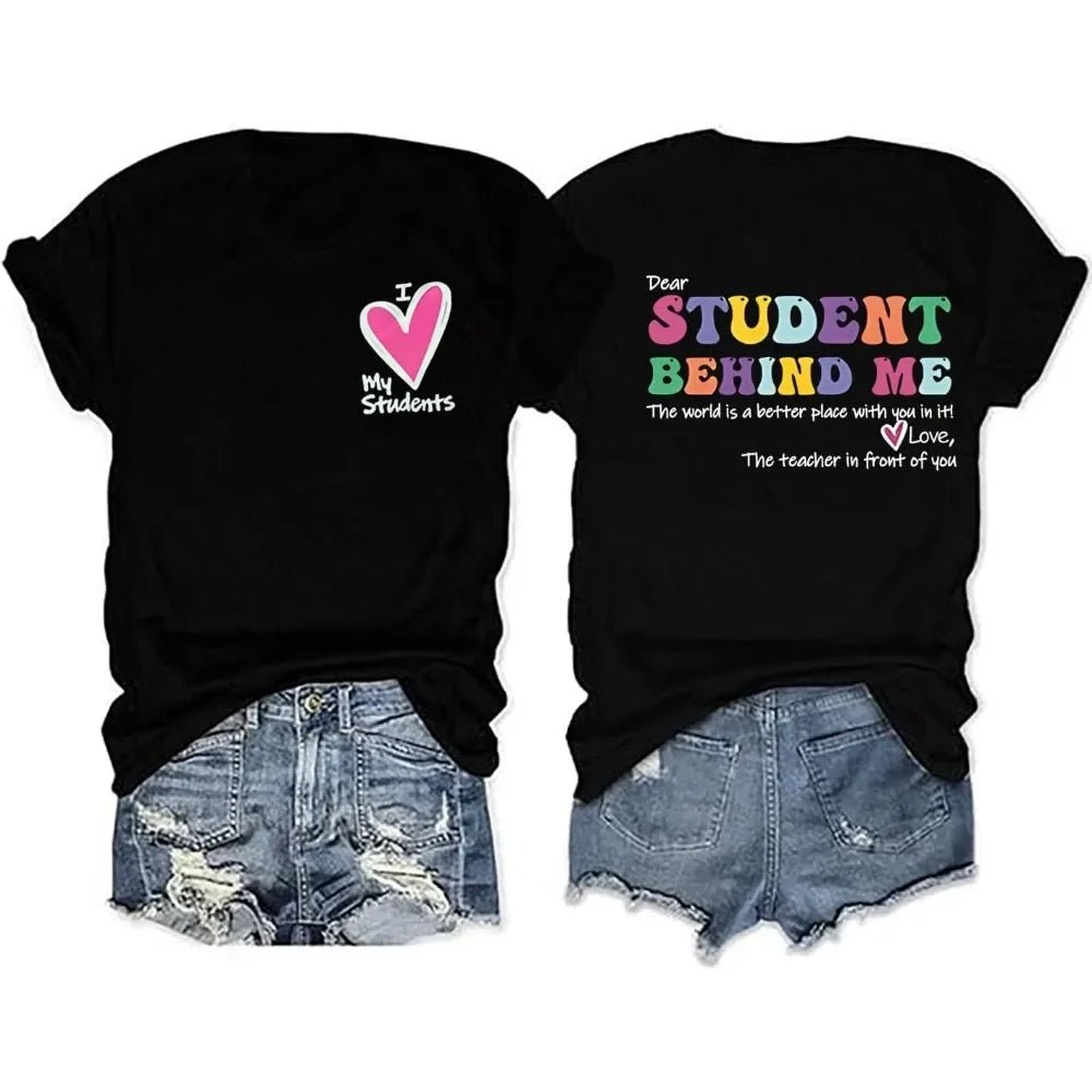 Front and Back view: Spread positivity with the "Dear Student Behind Me, The World Is a Better Place With You In It" T-Shirt from TeachingTeez.com! This inspirational tee is perfect for K-12 educators who want to uplift their students. Made from high-quality fabric, this comfortable black shirt is ideal for any classroom. Show your appreciation and inspire with this cute teacher t-shirt—order yours today at TeachingTeez.com!