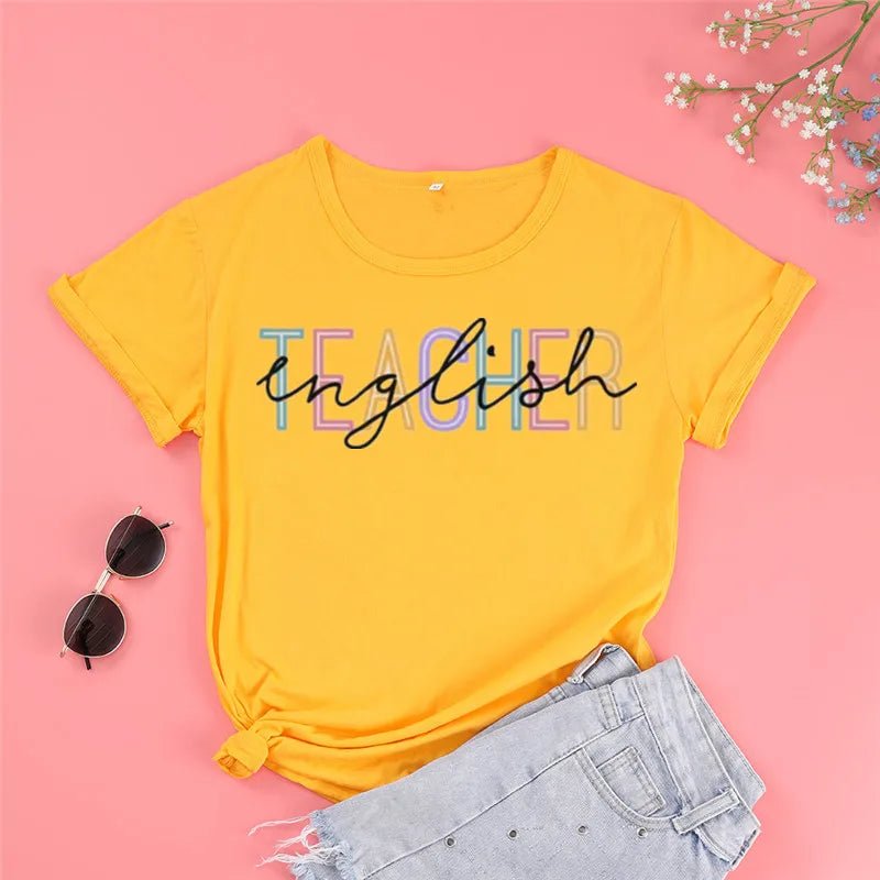 Front view of a stylish 'English Teacher' t-shirt in yellow, featuring bold black lettering overlaying colorful 'Teacher' text. Perfect for showcasing your passion as a cute teacher t-shirt. Shop today at TeachingTeez.com!