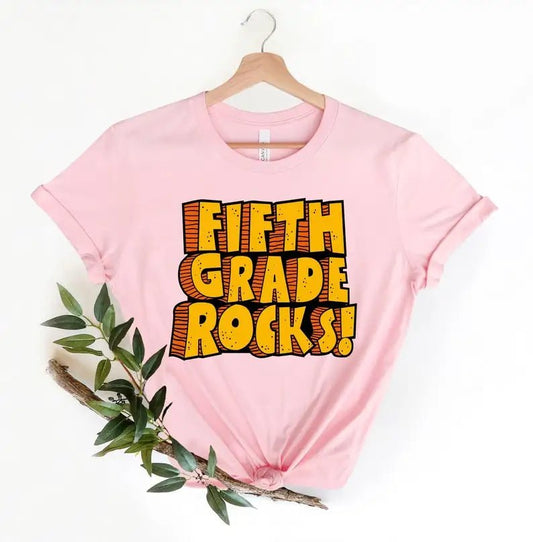 Pink Version:
Celebrate fifth-grade pride with the "Fifth Grade Rocks" T-Shirt from TeachingTeez.com! Perfect for fifth-grade teachers, this bold design made from soft, high-quality fabric for all-day comfort. Whether it’s for Teacher Appreciation or daily wear, this fun and stylish teacher t-shirt is a must-have for any educator. Order yours today at TeachingTeez.com!