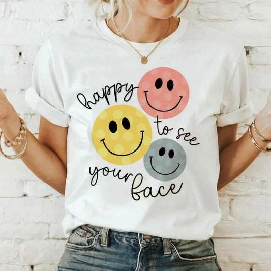 Spread positivity with the "Happy to See Your Face" T-Shirt from TeachingTeez.com! Featuring colorful smiley faces, this happy teacher t-shirt is perfect for brightening your classroom and sharing joy with students. Made from soft, breathable fabric, it's ideal for long school days or casual wear. A great gift for any teacher who loves to inspire happiness in their classroom. Order yours today at TeachingTeez.com!