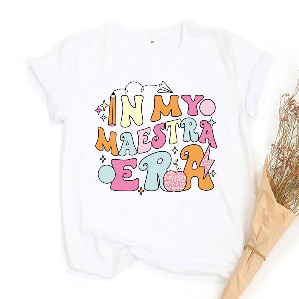 "In My Maestra Era" T-Shirt - TeachingTeez.com. Pastel theme. Featuring a pink cheetah print apple and lighting bolt, along with a variety of other designs. Shop today at teachingteez.com!