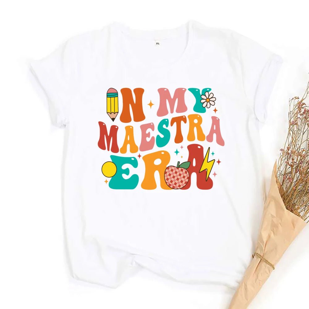 "In My Maestra Era" T-Shirt - TeachingTeez.com. Retro theme. Featuring a lightning bolt, checkered apple, and a variety of other designs. Shop today at teachingteez.com!