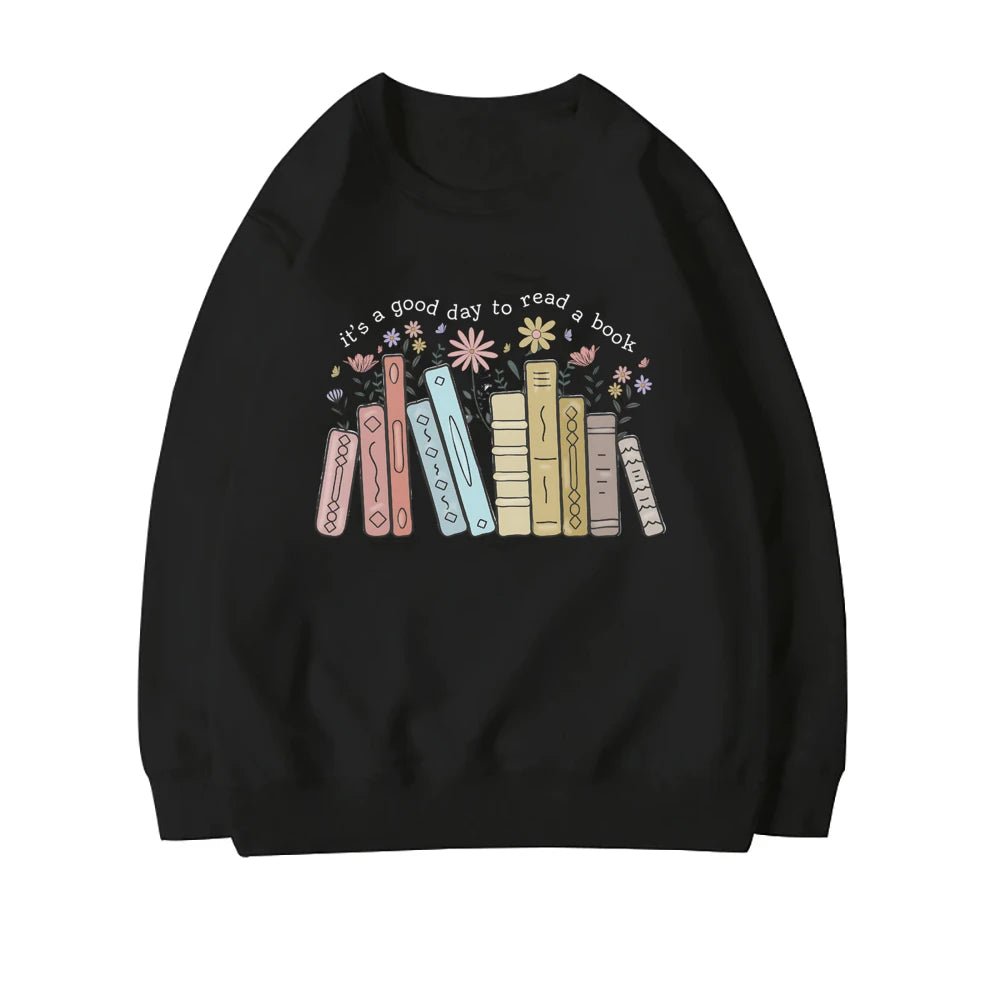 Black sweatshirt with a whimsical "It's a Good Day to Read a Book" design, showcasing pastel-colored books and blooming flowers. This cozy teacher sweatshirt is ideal for book lovers and educators looking to add literary flair to their wardrobe. Available now at TeachingTeez.com.